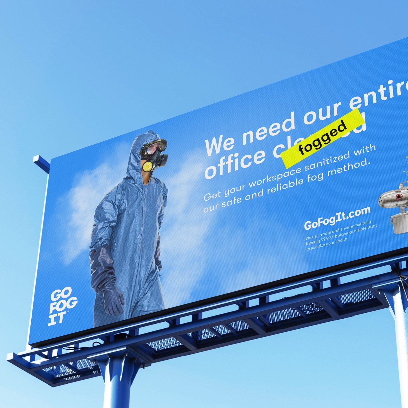 Go Fog It Billboard with a blue sky background, that has a person in a hazmat suit