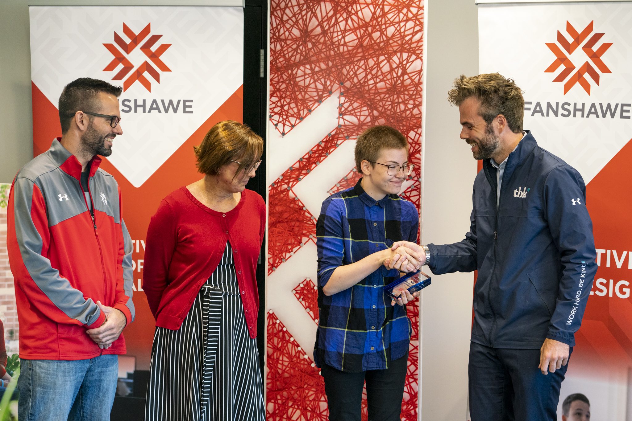 Fanshawe College student Breanna Trachsell being awarded tbk's Women in Tech Scholarship by tbk's president, Andrew Schiestel.