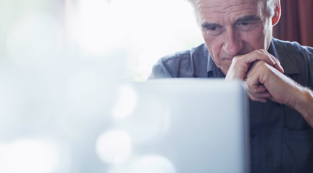 older man in front of computer screen