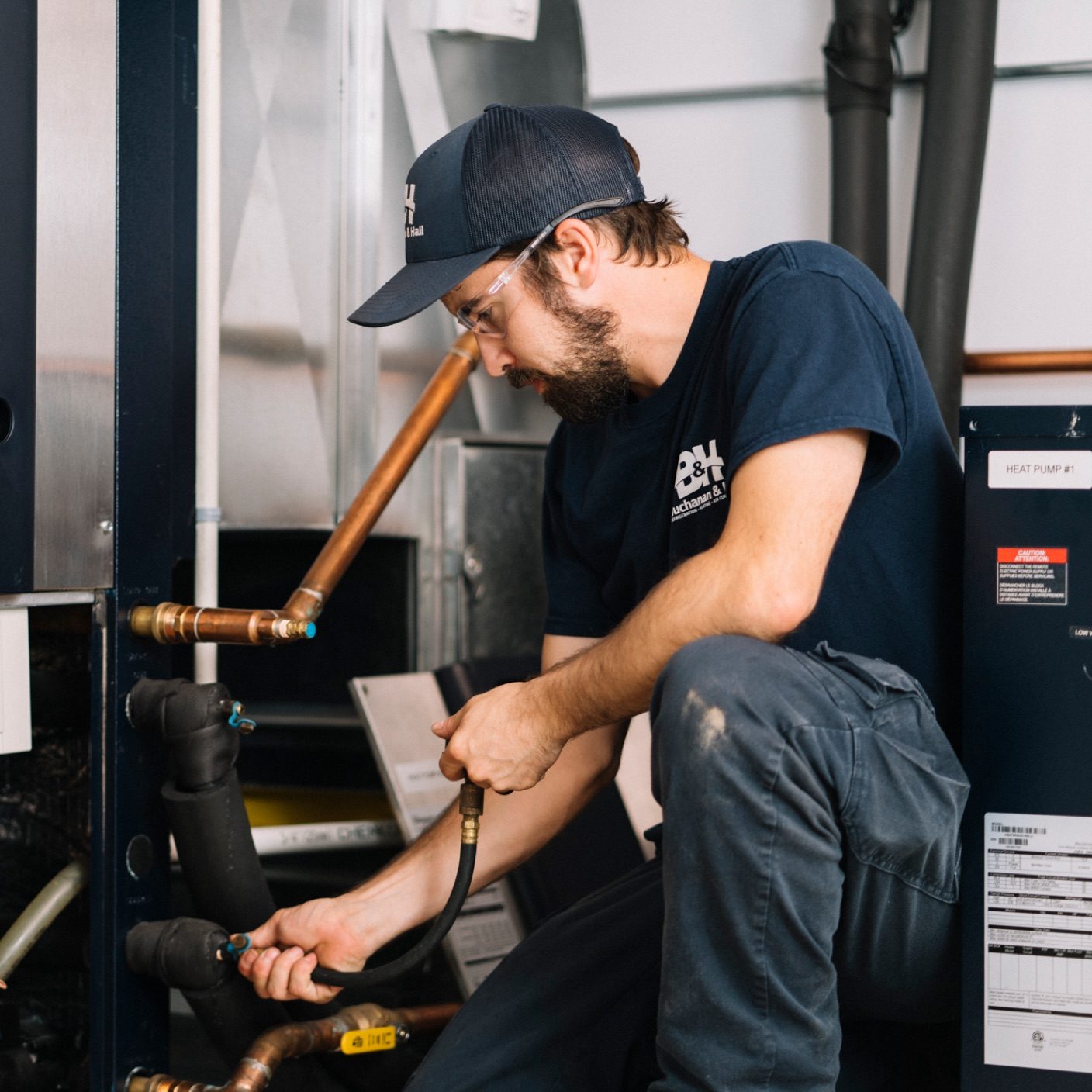 BH Male technician kneeling down performing a mechanical test