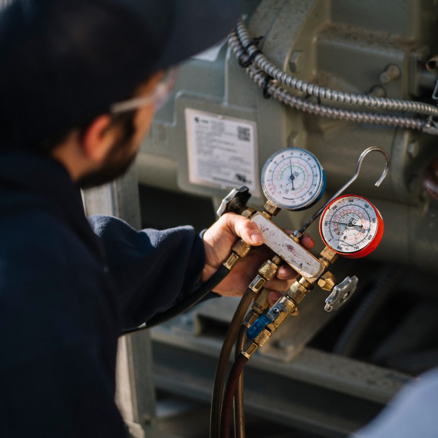 BH work shot of technician using a pressure measurement tool