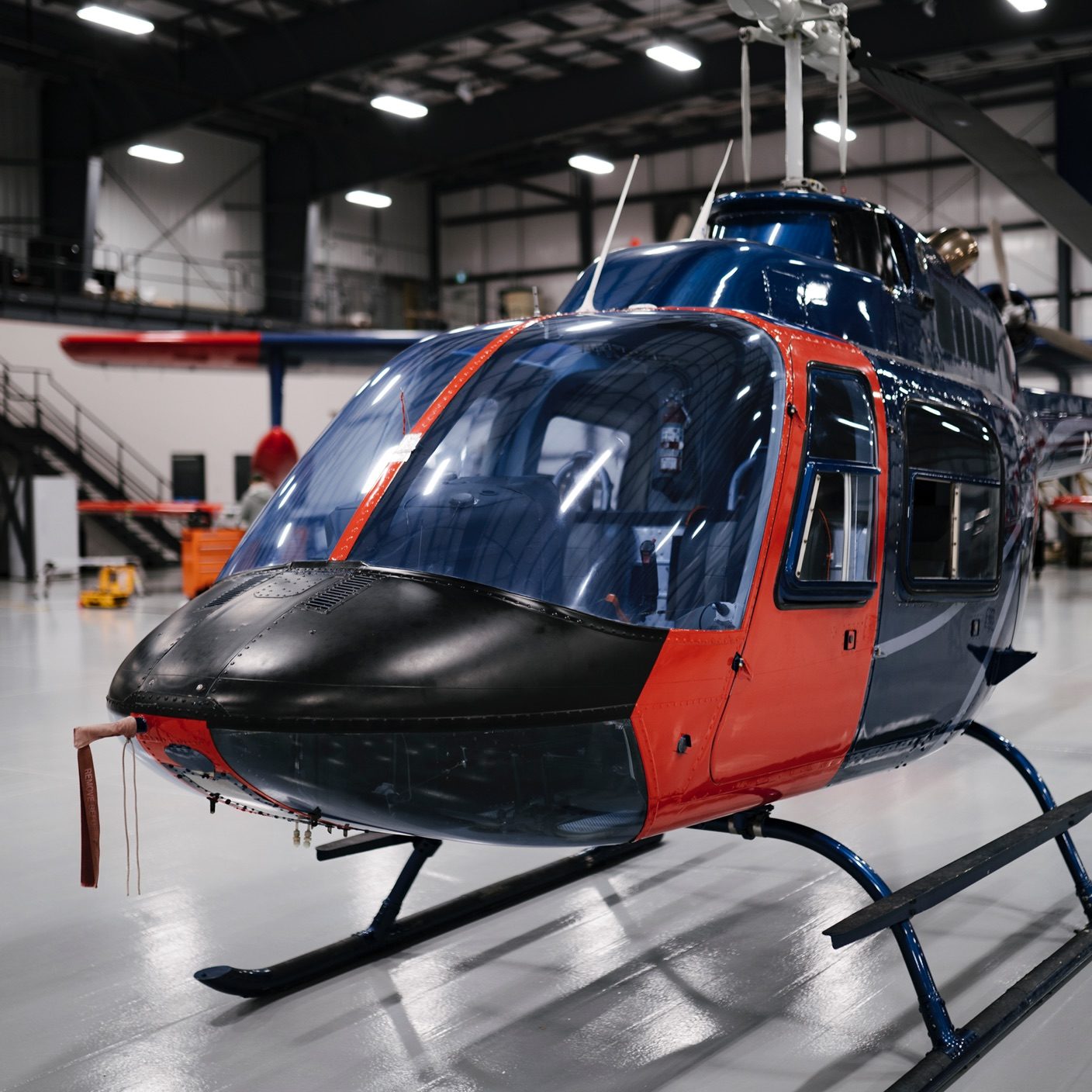 blue and red helicopter in a warehouse