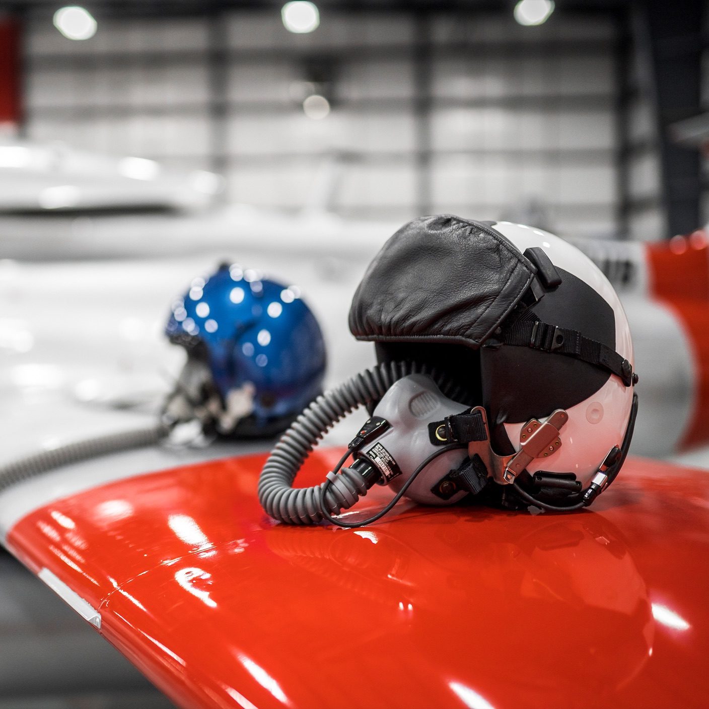 helmet in a warehouse resting on an orange surface with another helmet in the background